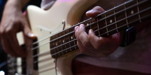 Part of bass guitar close up while playing.